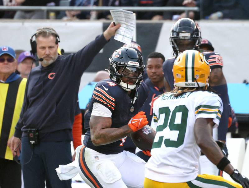 Chicago Bears running back D'Andre Swift looks to get by Green Bay Packers safety Xavier McKinney on his way to a touchdown as head coach Matt Eberflus looks on Sunday, Nov. 17, 2024, during their game at Soldier Field in Chicago.
