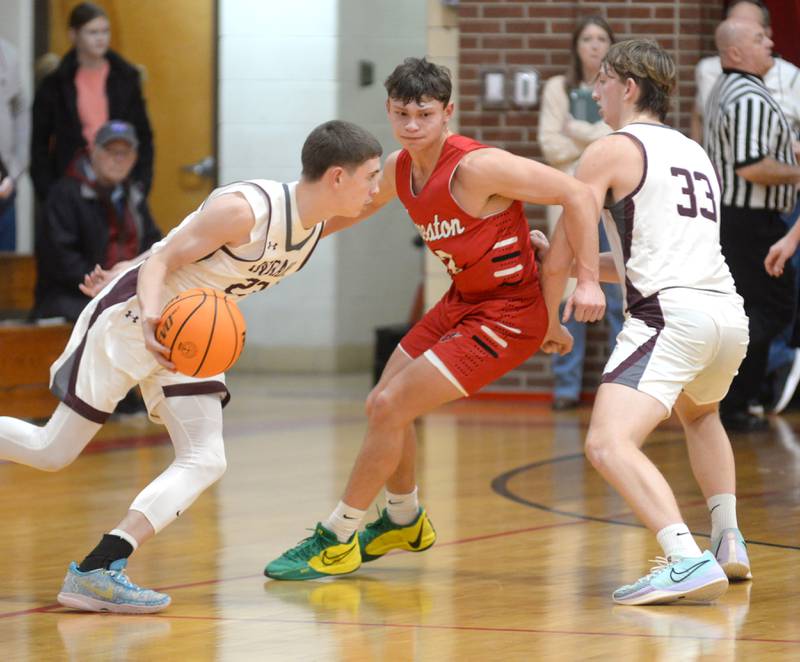 Forreston's Kendall Erdmann (center) fights over a screen as he guards Dakota's Liam Burke on Tuesday, Dec. 17, 2024 at the 63rd Annual Forreston Holiday Tournament.