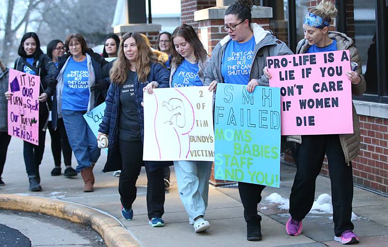 The last working shift holds signs outside St. Margarets Hospital on Saturday, Jan. 28, 2023 in Peru. Employees and former employees gathered at the hospital after it closed at 7a.m. on Saturday morning. Hospital officials announced late last Friday their plans to suspend operations at St. Margaret's Health in Peru.