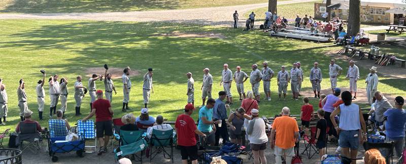 The Oregon Ganymedes (right) line up with the Columbus Buckeyes following the teams' first game at the World Tournament of Historic Base Ball  held at the Henry Ford Museum's Greenfield Village Saturday,  Aug. 9, 2025 in Dearborn, Michigan.