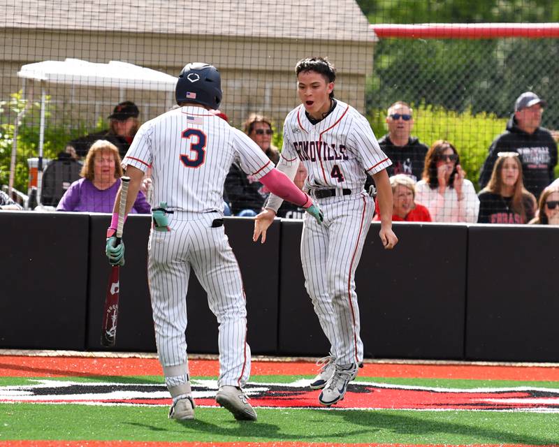 Romeoville's Nolan Holgado (4) celebrates with teammate Karlos Otero (3) after scoring a run during the regional game against Yorkville on Thursday May 29, 2025, held at Yorkville High School.