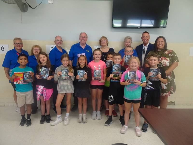 Putnam County third grade students posed proudly with their new personal dictionaries presented to them by Putnam County Rotarians on Oct. 3. Pictured in the back row are (from left) Rotarians Sue Motley, club president and literacy chair Adriane Shore, Pastor Ron McNeill, Scott Shore, Brenda Bickerman, Cheri Adrian and Jay McCracken, joined by Putnam County Elementary Principal Courtney Balestri.