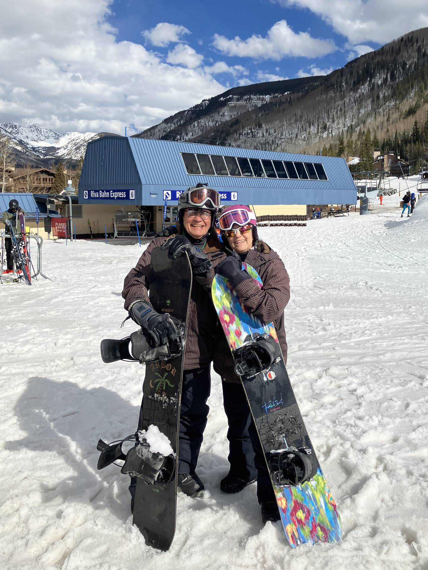 Chuck and Lydia Roberts pose with snowboards.