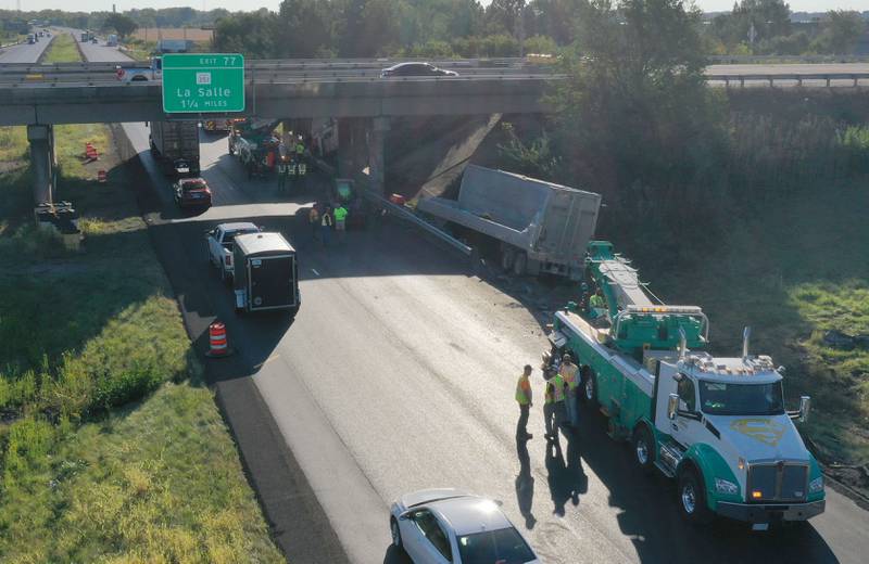 Emergency crews work the scene of a semi truck that struck the overpass of Illinois Route 251 and Interstate I-80 on Friday, Sept. 26, 2025 in Peru. The driver of the semi had to be extricated. Illinois State Police, Peru Fire and EMS, Senica Towing and Illinois Department of Transportation were all on the scene.