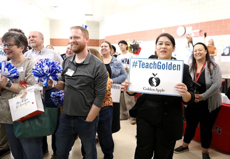 Students, colleagues and family, including husband Brian Clifford (center) surprised Bolingbrook High School teacher Erin Clifford as it was announced she had won a Golden Apple Award for Excellence in Teaching.