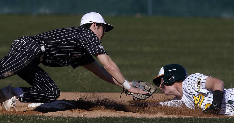 Prairie Ridge's Brennan Coyle tags out Crystal Lake South’s Liam Sullivan as he tries to steal second base during a Fox Valley Conference baseball game on Monday, April 8, 2024, at Crystal Lake South High School.