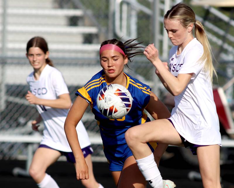 Johnsburg’s London Baidinger, center, battles North Shore Country Day’s Kate Connolly, right, in IHSA Class 1A Sectional Title Game action at Richmond-Burton High School in Richmond on Tuesday, May 27, 2025.