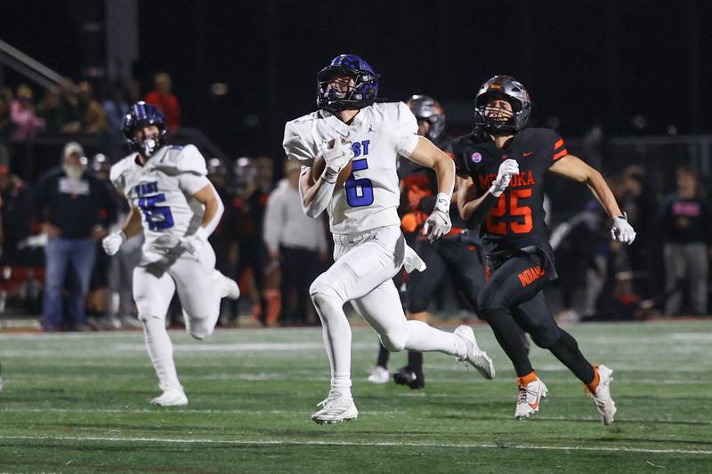 Lincoln-Way East’s Keagan Ruane breaks away for a touchdown after a catch against Minooka on Friday, Nov. 8, 2024 in Minooka.