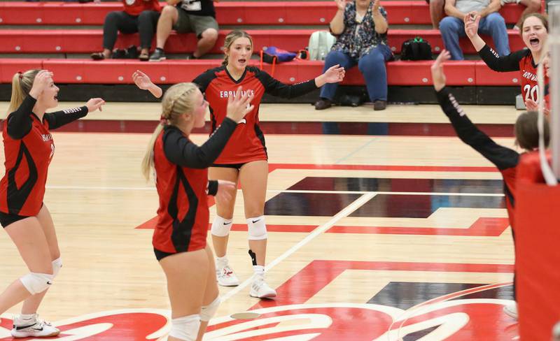 Members of the Earlville volleyball team react after defeating Somonauk on Tuesday, Aug. 29, 2023 at Earlville High School.