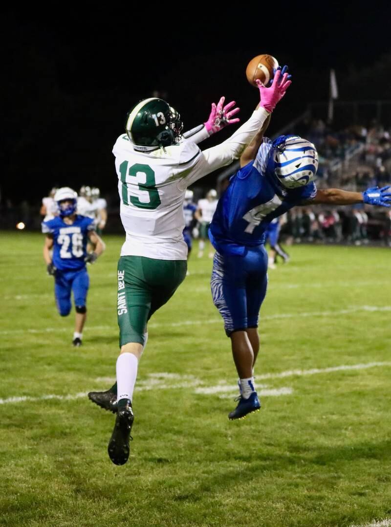 St. Bede's Ben Wallace grabs a pass over Princeton's Andrew Peacock Friday Night at Bryant Field. The Tigers won 56-7.