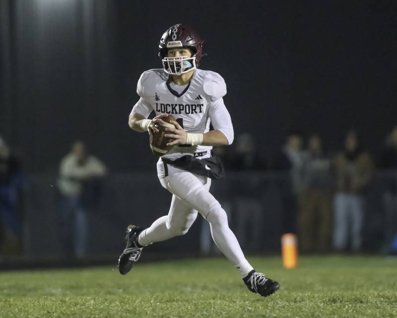 Lockport's Brendan Mecher (1) rolls out looking for an open receiver during Class 8A semifinal football game between Lockport at Oswego. Saturday, Nov 22, 2025 in Oswego.