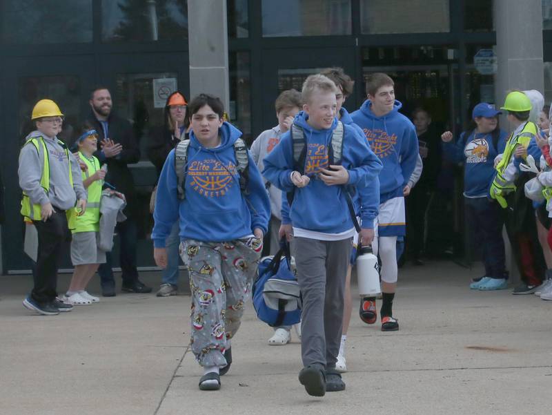 Members of the Oglesby Washington 7th grade basketball team exit the school to board a charter bus to attend the Illinois Elementary School Association Class 2A State championship on Thursday, Feb. 8, 2024 at Oglesby Washington School. Oglesby plays Effingham for the Class 2A State Title.
