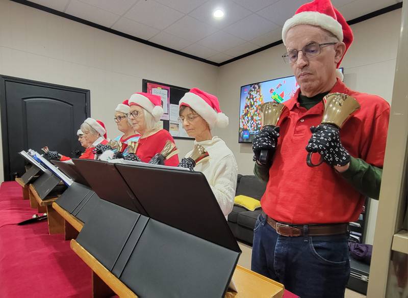 The Elm City Bell Ringers, performing at the Ladd Library, entertained many attending the Ladd Christmas Parade on Saturday.