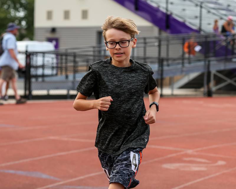 Raymond Curran runs the mile at the community festival and running fundraiser for mental health awareness and suicide prevention in honor of Ben Silver.  July 23, 2022.