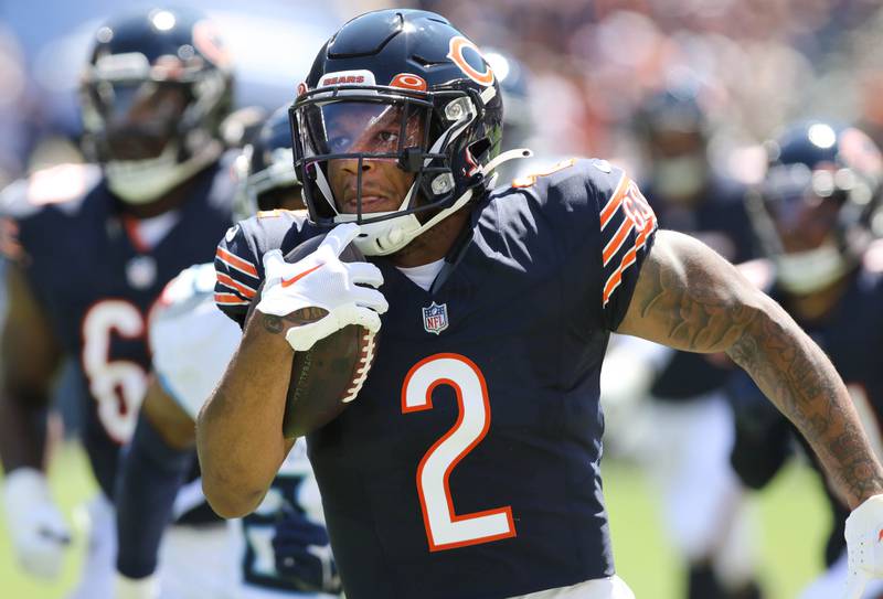 Chicago Bears wide receiver DJ Moore carries the ball to the end zone after catching a pass from Justin Fields in the first quarter of their preseason game against the Tennessee Titans Saturday, Aug. 12, 2023, at Soldier Field in Chicago.