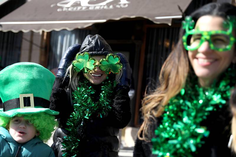 Angelo Franchi, 7, Cyndi Van (left) and Angie Franchi watch the St. Charles St. Patrick’s Parade in downtown St. Charles on Saturday, March 12, 2022.