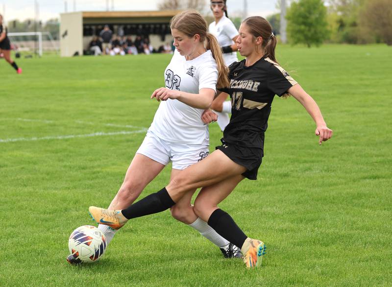 Kaneland's Bella Gruber (left) tries to hold off Sycamore's Addison Rodriguez during their game Wednesday, April 29, 2026, at Sycamore High School.