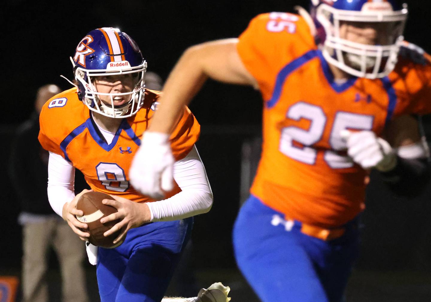 Genoa-Kingston's Nathan Kleba rolls out to pass as Peyton Meyer heads out on a route during their game against Winnebago Friday, Sept. 27, 2024, at Genoa-Kingston High School.