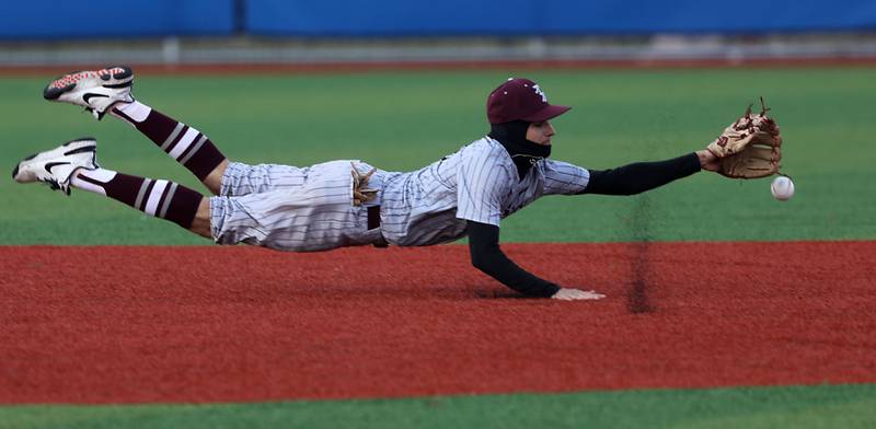 Richmond-Burton's Ryan Scholberg tries to come up with a diving catch during a Kishwaukee River Conference baseball game against Johnsburg on Monday, April 6,2026, at Johnsburg High School.