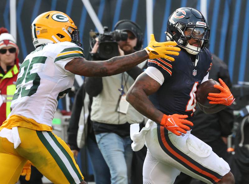 Chicago Bears running back D'Andre Swift gets by Green Bay Packers cornerback Keisean Nixon on his way to a touchdown Sunday, Nov. 17, 2024, during their game at Soldier Field in Chicago.