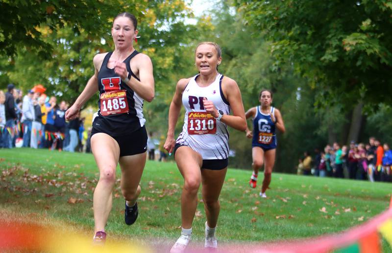 Huntley’s Morgan Sauber, left, and Prairie Ridge’s Anneke Dam battle at the finish during the Fox Valley Conference Cross Country Meet at McHenry County College in Crystal Lake on Saturday, October. 18, 2025.