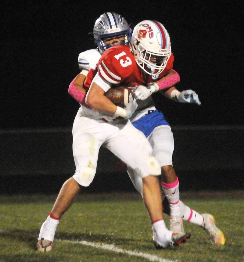 Woodstock ball carrier Charles Gilmore (6) tries to get past the Ottawa defense of Conner Price (12) and Trey Donnely at King Field on Friday, Oct. 21, 2022.