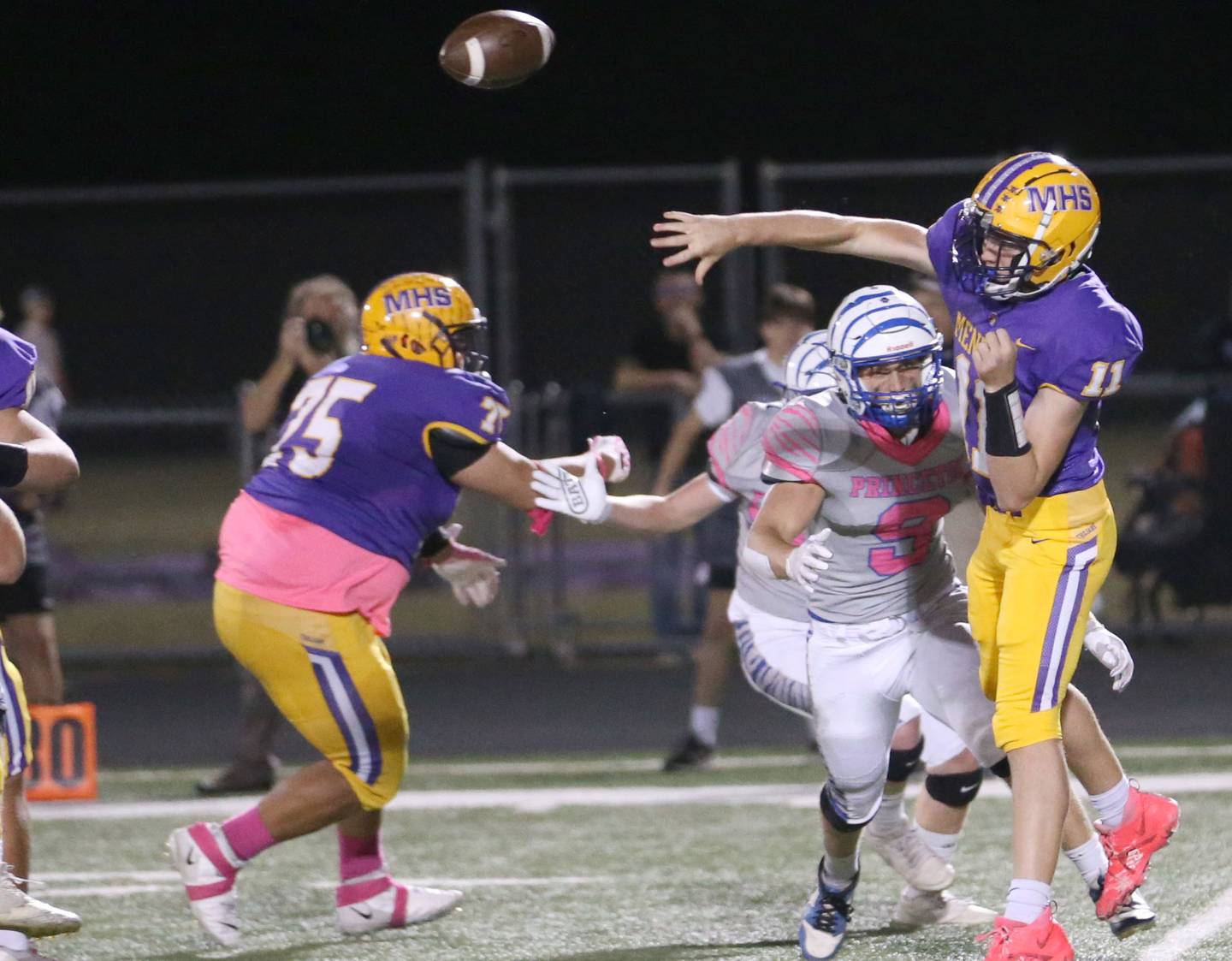 Mendota quarterback Aden Tillman throws a pass as Princeton's Arthur Burdan defends on Friday, Oct. 11, 2024 at Mendota High School.