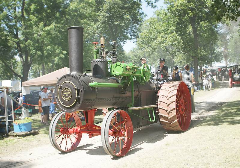 The 1916 steam engine made by the Illinois Thresher Company in Sycamore in its first parade appearance driven by show director Dan Stevens on Thursday, August 14, 2014, at the Northern Illinois Steam Power Club's Steam Show and Threshing Bee at Taylor Marshall Farm in Sycamore.