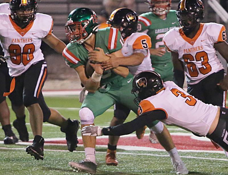 L-P's quarterback Brendan Boudreau carries the football as United Township players try to tackle him on Friday, Aug. 26, 2022 at Howard Fellows Stadium in Peru.