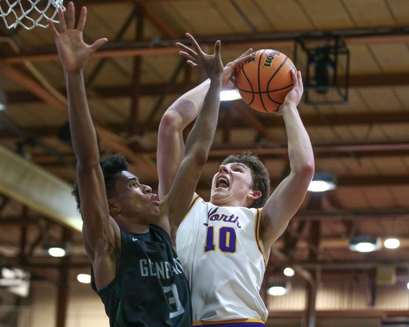 Downers Grove North's Bobby Grganto (10) is challenged at the rim by Glenbard West's TJ Williams (3) during their basketball game between Glenbard West at Downers Grove North. Jan 24, 2025 in Downers Grove.