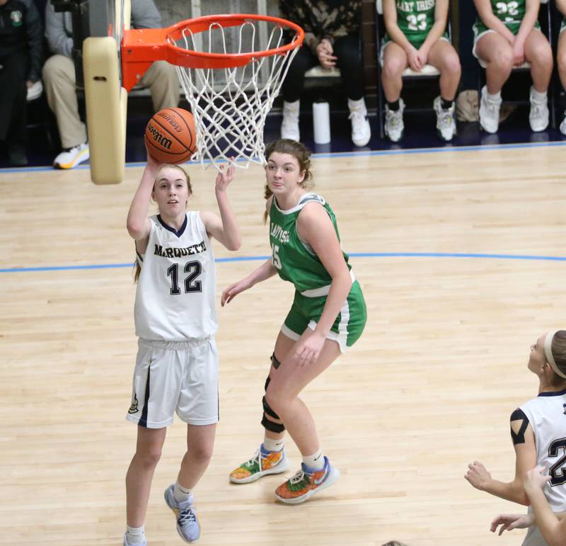 Marquette's Lily Craig dribbles around Seneca's Tessa Krull to score a basket in Bader Gym on Monday, Jan. 23, 2023 at Marquette High School.