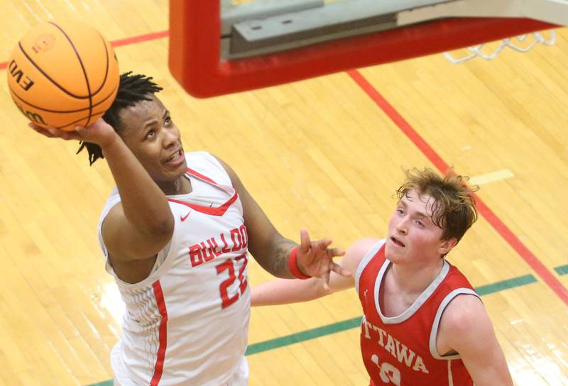 Streator's Tristan Finley eyes the hoop as Ottawa's Evan Snook defends the lane during the Class 3A Regional semifinal game on Wednesday, Feb. 26, 2025 in Sellett Gymnasium at L-P High School.