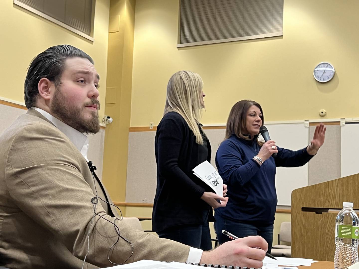 DeKalb County Administrative Analyst, Liam Sullivan looks on as DeKalb County Convention and Visitors Bureau’s Executive Director, Corteny Strohacker and marketing specialist, Katherine McLaughlin present to DeKalb County Board's Committee of the Whole on Jan. 11, 2023. McLaughlin and Strohacker told the board the bureau – which seeks to attract visitors who live more than 55 miles from DeKalb County – won two awards in 2022 and worked with a handful of influencers in an effort to expand their social media presence.