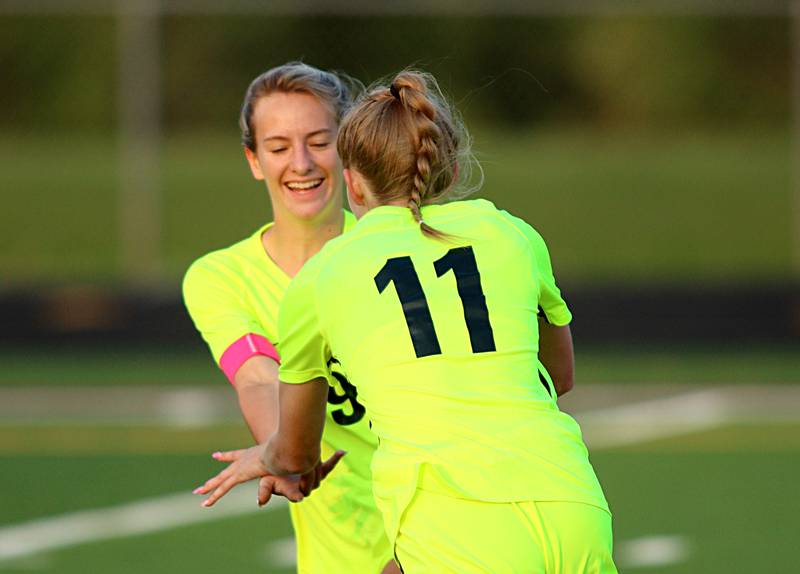 Richmond-Burton’s Margaret Slove is congratulated by Reese Frericks after Slove scored against Willows in Class 1A Sectional title soccer action at Richmond Friday night.