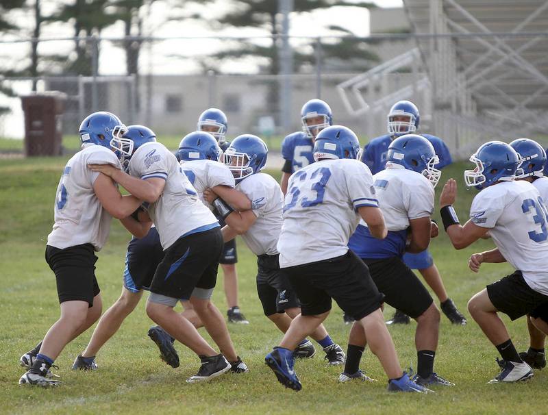 Burlington Central football players run drills during a recent practice at the school.