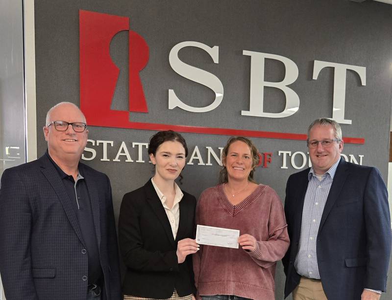Pictured are Doug Parrott, President and CEO of SBT, Chloe Lund, Chief Operating Officer for Freedom House, Jennifer Tanner Beaver, Freedom House Board Member and Doug Blunier, Executive Vice President and Chief Lending Officer, presenting Tanner Beaver with a check for $50,000 towards the renovation of the Kewanee domestic violence shelter