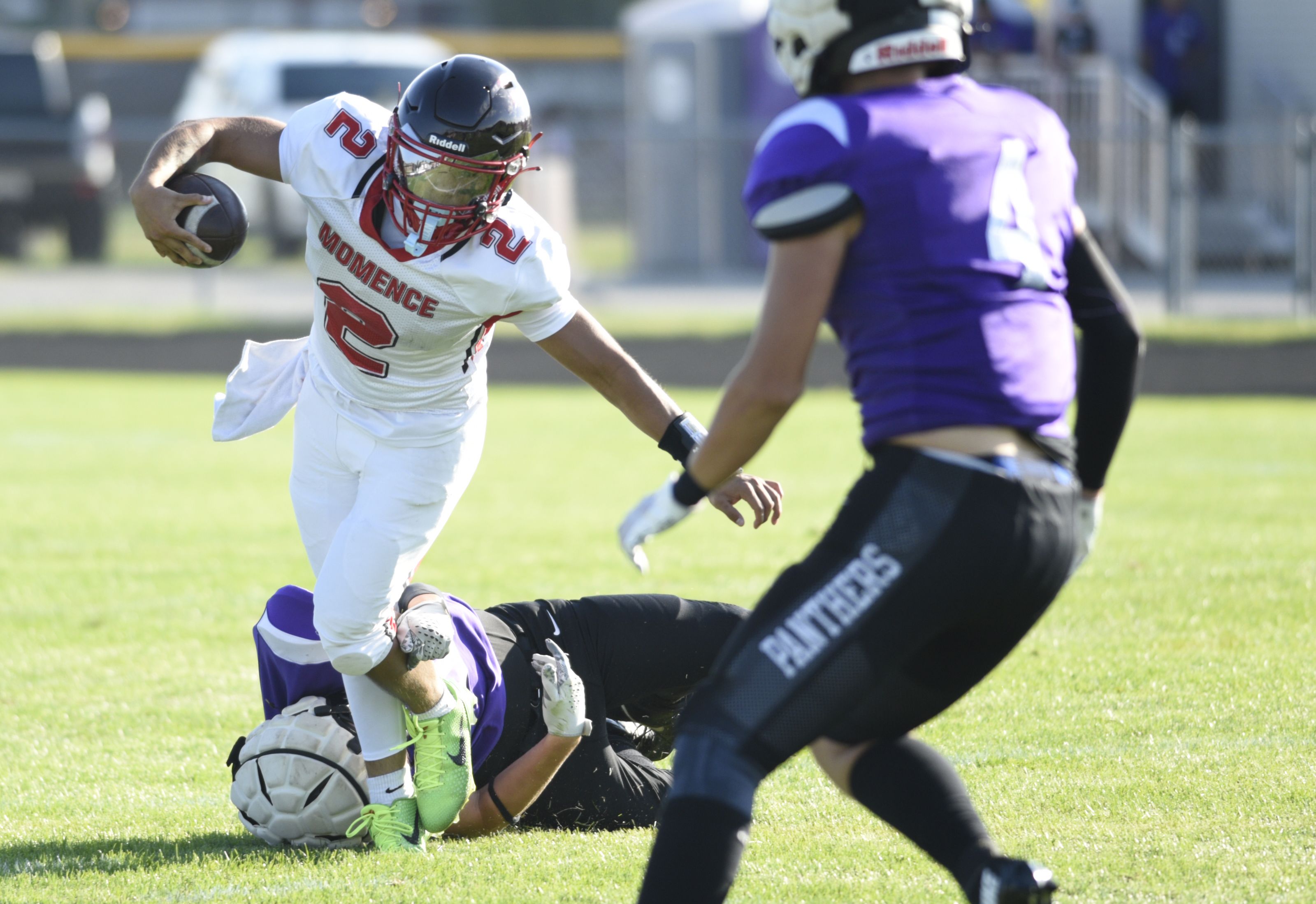 Momence's Erick Castillo evades a tackle as he carries the ball in a scrimmage game against Manteno on Friday, August 22, 2025. 