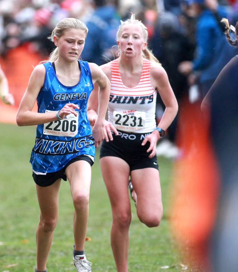 Geneva’s Sofia Borter (left) and St. Charles East's Adley Wilson compete in the Class 3A State Cross Country Championships on Saturday, Nov. 9, 2024 at Detweiller Park in Peoria.