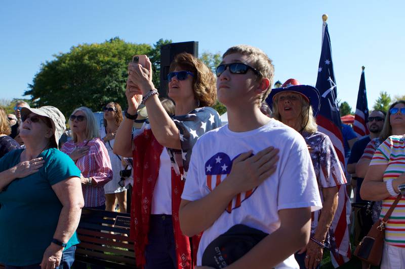 Patriot's salute the flag as it is raised at the Flag Day Monument opening ceremony's at Patriot's Park on Sunday, Oct 1,2023 in Batavia.