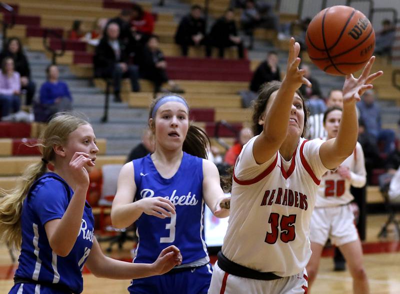 Huntley's Paula Strzelecki grabs a rebound in front of Burlington Central's Ashley Waslo (left) and Savannah Scheuer (center) during a Fox Valley Conference girls basketball game Friday, Feb.2, 2024, at Huntley High School.