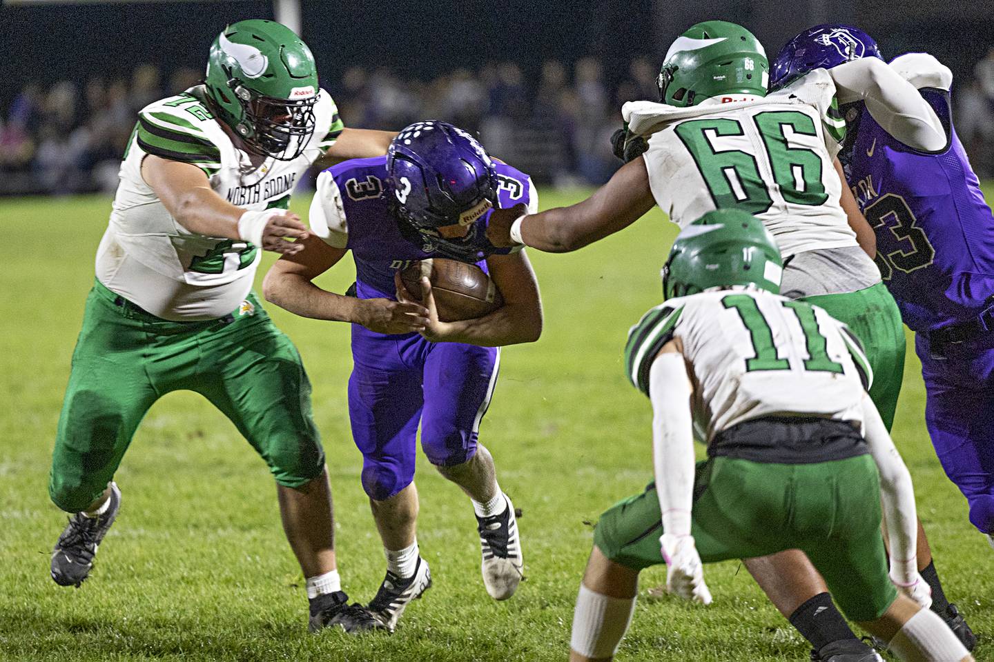 Dixon’s Tyler Shaner has his facemark held by North Boone’s Dominick Rayas Friday, Oct. 20, 2023 in Dixon.