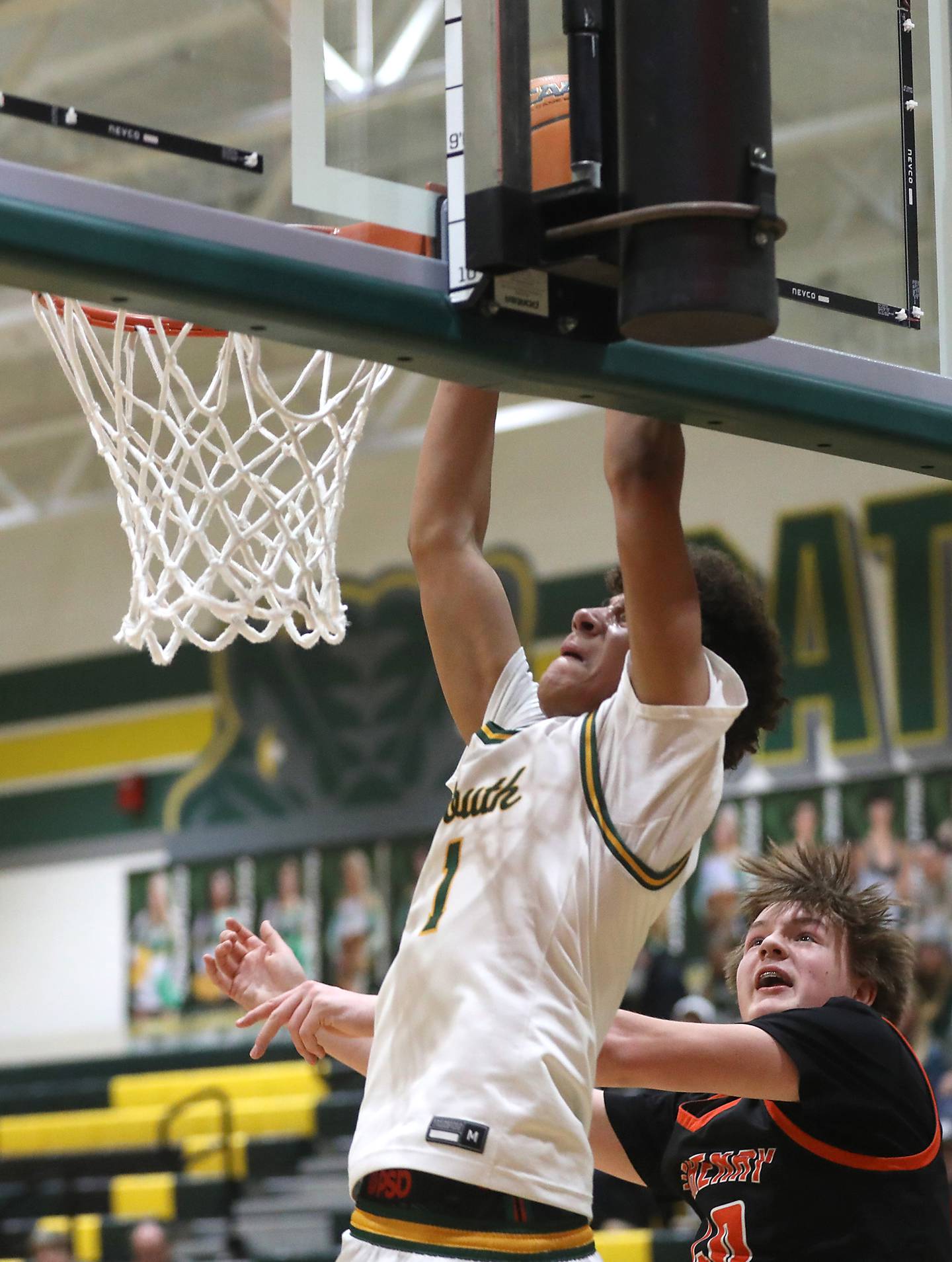 Crystal Lake South's Noah Cook dunks the basketball in front of McHenry's Nate Ottaway during a Fox Valley Conference boys basketball game on Wednesday, Jan. 14, 2026, at Crystal Lake South High School.