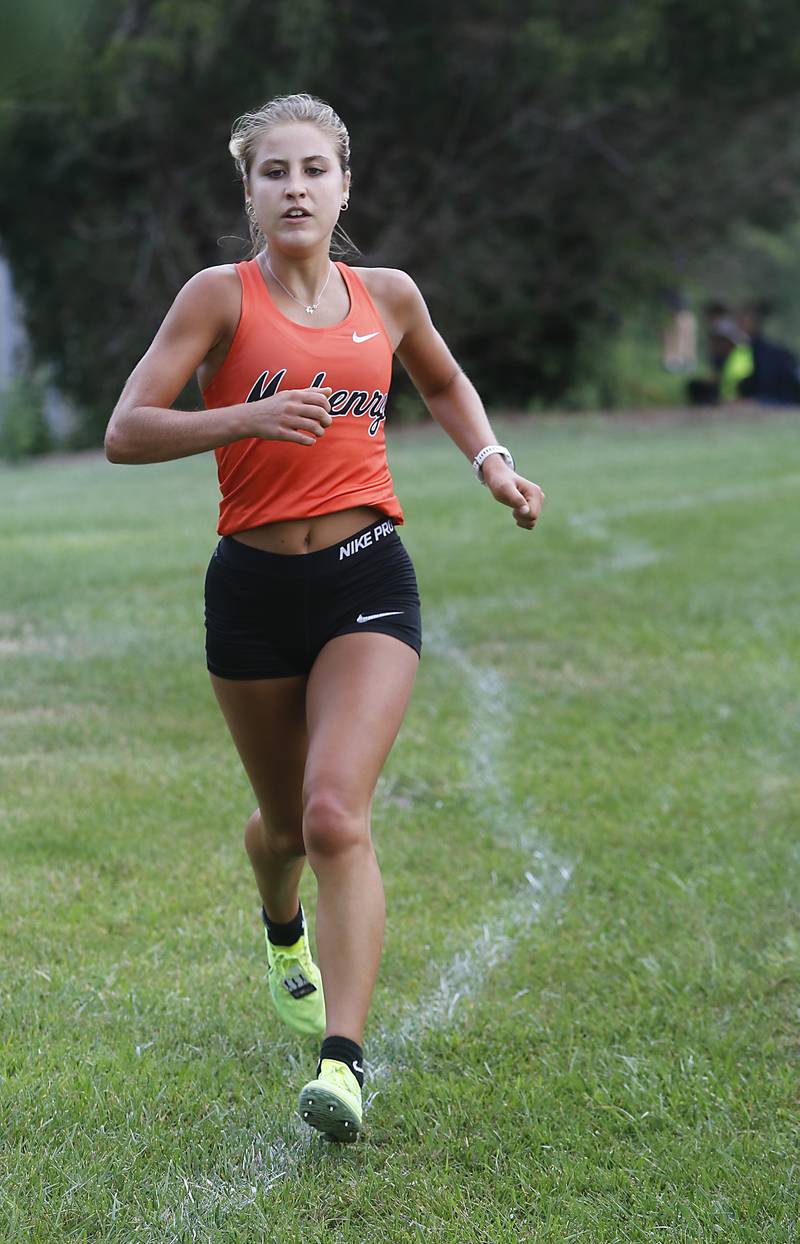 McHenry’s Danielle Jensen leads the girls race of the McHenry County Cross Country Meet Saturday, August 27, 2022, at Emricson Park in Woodstock.
