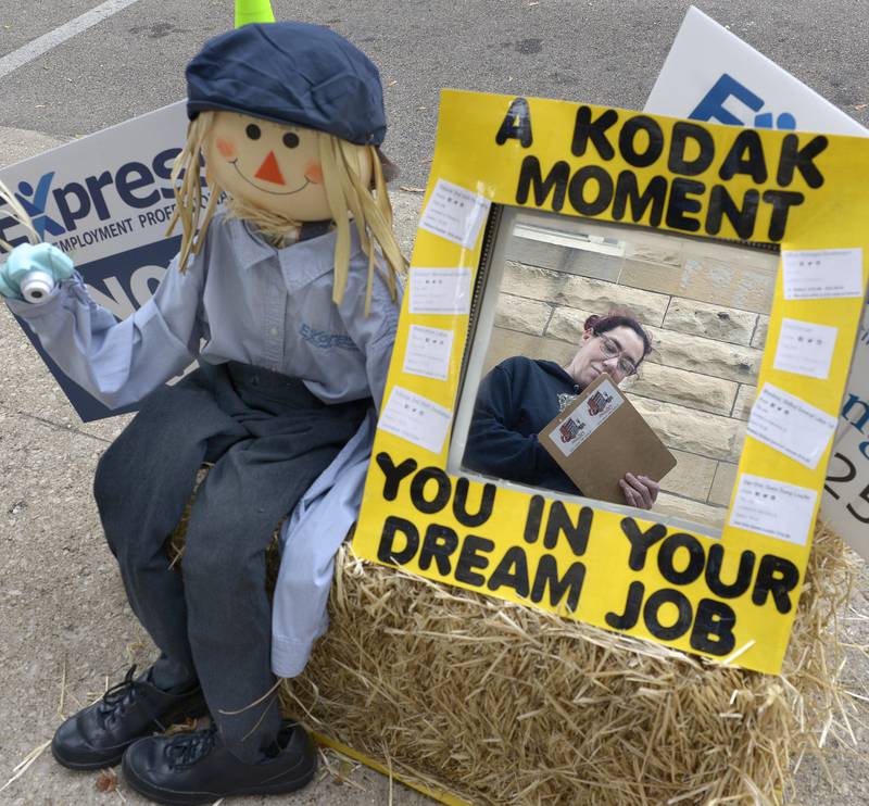 Scarecrow judge Chrystal Schaffer jots down notes Saturday, Sept. 28, 2024, as she looks over this scarecrow along La Salle Street during the annual Scarecrow Fest in Ottawa.