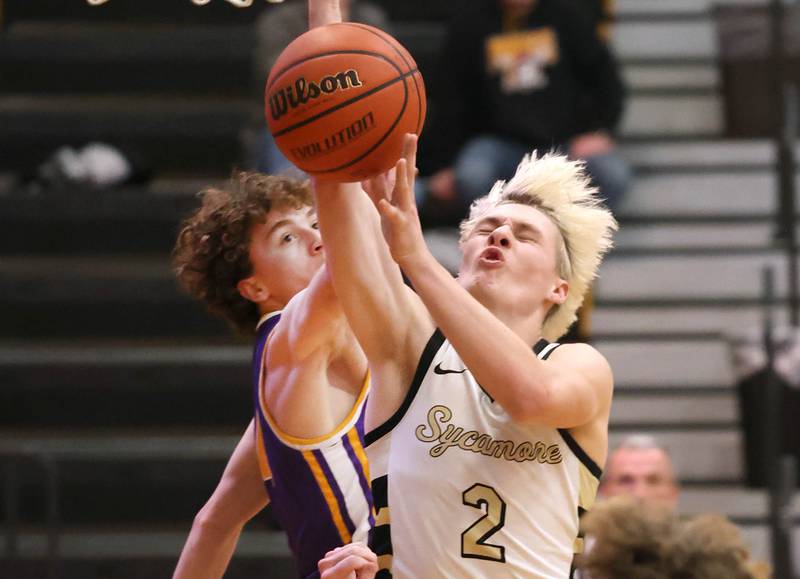 Sycamore's Aidan Wyzard is fouled by Mendota's Jace Baird as he goes to the basket during their game Wednesday, Dec. 13, 2023, at Sycamore High School.