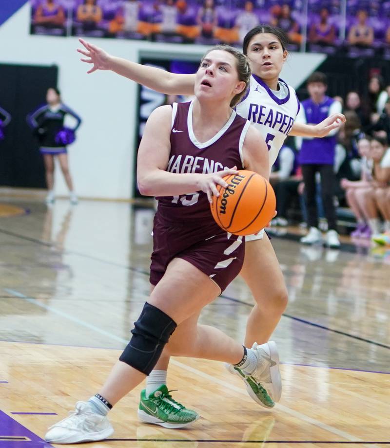 Marengo’s Emilie polizzi (15) drives to the hoop against Plano’s Alanna Roldan (5) during a basketball game at Plano High School on Wednesday, January 29, 2025.