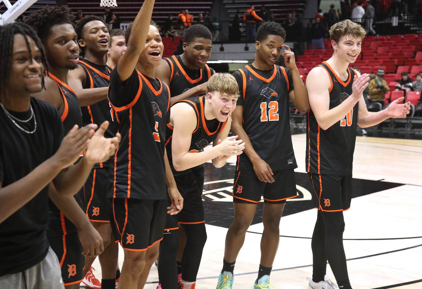 DeKalb players celebrate after their win over Sycamore Friday, Jan. 31, 2025, in the FNBO Challenge in the Convocation Center at Northern Illinois University in DeKalb.