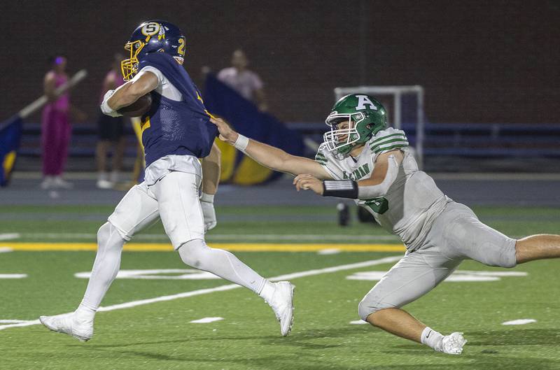Sterling’s Brady Hartz is grabbed by the jersey by Alleman’s Kelly Honert Friday, Oct. 3, 2025.
