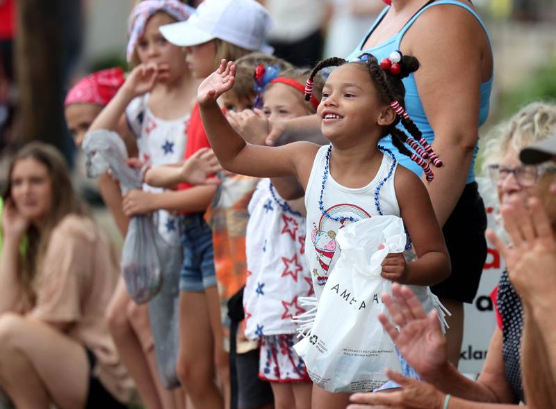 Attendees wave at the fire trucks as they head down Main Street Friday, July 4, 2025, during the Fourth of July parade in downtown Kirkland.