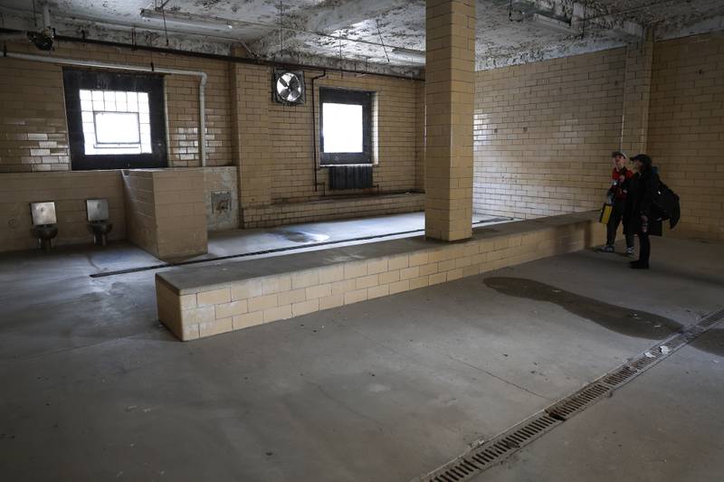 Several fans tour the shower room before the Joliet Slammers preseason game at the Old Joliet Prison on Thursday, April 29, 2026 in Joliet.